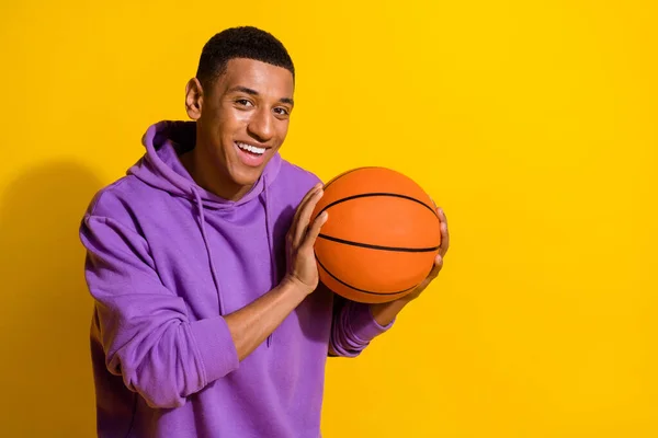 Portrait of attractive cheery sportive guy playing basketball having fun isolated over bright yellow color background — 스톡 사진
