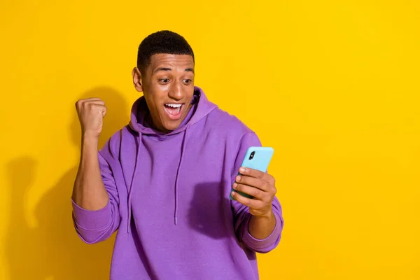 Portrait of attractive cheerful guy using device having fun copy space 5g isolated over vivid yellow color background —  Fotos de Stock