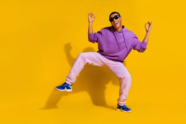 Full length body size view of attractive trendy carefree guy dancing showing ok sign isolated over bright yellow color background — Fotografia de Stock