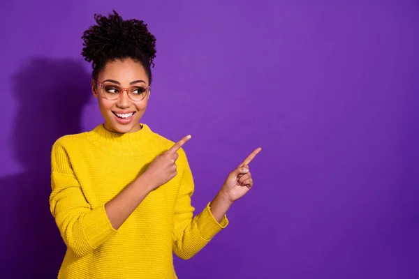 Portrait of positive charming lady look indicate finger empty space isolated on purple color background — Foto Stock