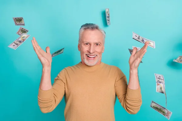 Photo of positive crazy person raise hands falling dollar banknotes isolated on turquoise color background — Foto Stock