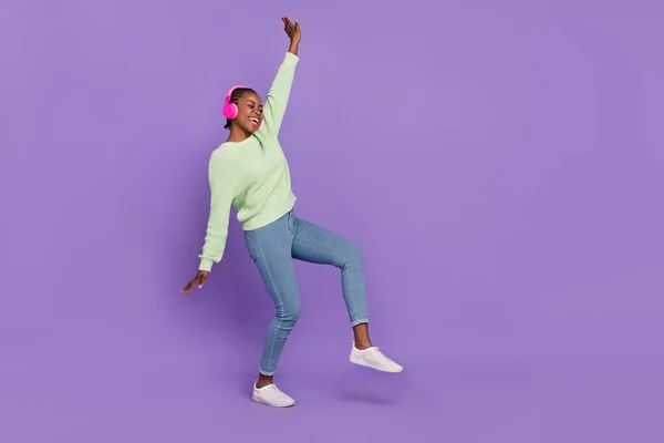 Full size image of cheerful female dancing in disco club enjoy rock metal music isolated on purple color background — Stock Photo, Image