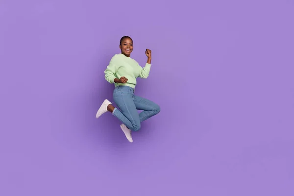 Full size photo of good mood emotion attractive female jump celebrate her victory isolated on purple color background — Stock fotografie