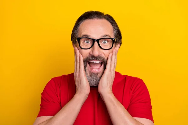Photo of mature excited man hands touch cheeks information discount isolated over yellow color background — Stockfoto