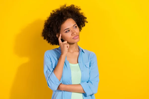 Photo of minded smart intelligent lady think look empty space wear jeans shirt isolated yellow color background — Stock fotografie