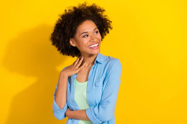 Photo of inspired dreamy charming lady look empty space hand neck wear jeans shirt isolated yellow color background — 스톡 사진