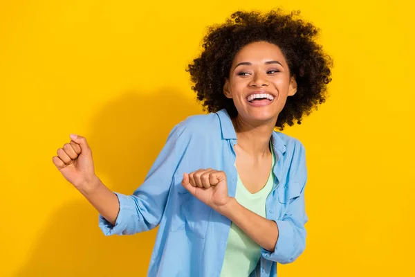 Photo of positive cheerful lady dance discotheque toothy smile wear jeans shirt isolated yellow color background — Stockfoto