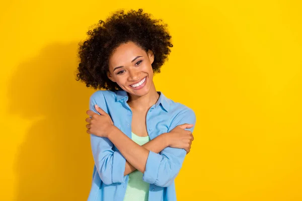 Photo of inspired peaceful relaxed lady embrace shoulders comforting wear jeans shirt isolated yellow color background — 스톡 사진