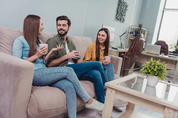 Photo of positive happy teachers group having coffee break talking sitting sofa indoors workplace workstation — Stock Photo, Image