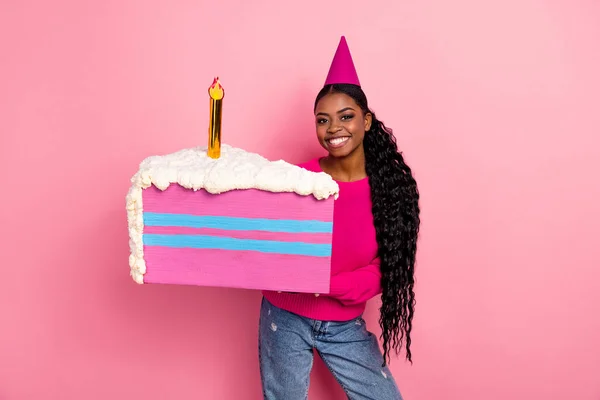 Photo of nice young brunette lady hold cake wear cap pullover isolated on pink color background — Zdjęcie stockowe