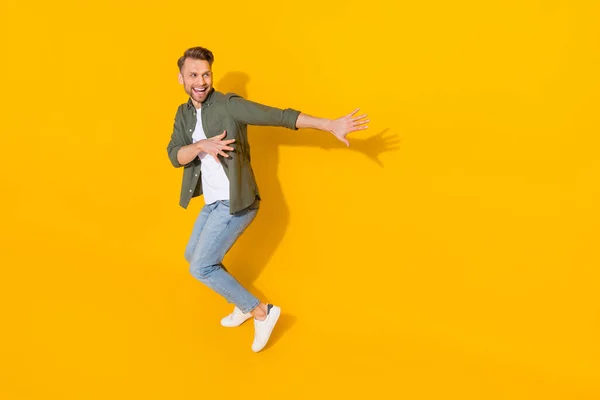 Full length body size view of attractive cheerful crazy guy dancing having fun isolated over bright yellow color background — Stockfoto