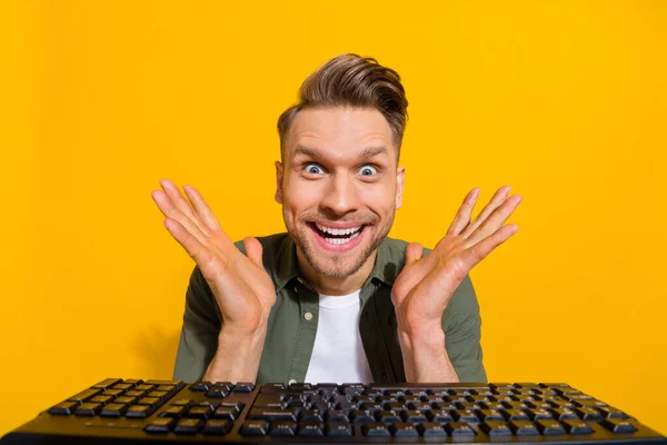 Portrait of attractive cheerful amazed guy gambling having fun e-sport isolated over bright yellow color background — Stockfoto