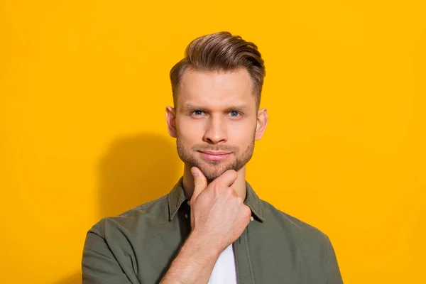 Portrait of attractive bewildered confident blond guy deciding touching chin isolated over bright yellow color background — Stock Fotó