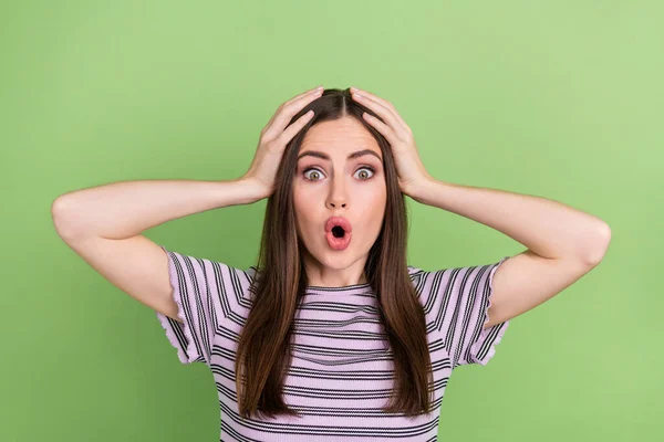 Portrait of attractive stunned funky girly brown-haired girl sudden news reaction oops isolated over bright green color background — Fotografia de Stock