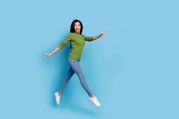 Full length body size view of attractive cheerful thin funky girl jumping walking having fun isolated over bright blue color background — Fotografia de Stock