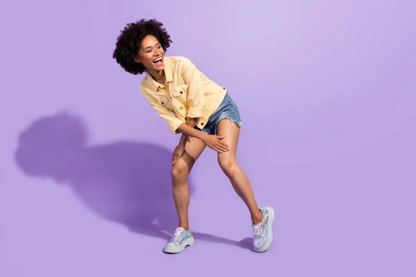 Photo of charming sweet woman dressed yellow jeans jacket smiling dancing isolated purple color background — Fotografia de Stock