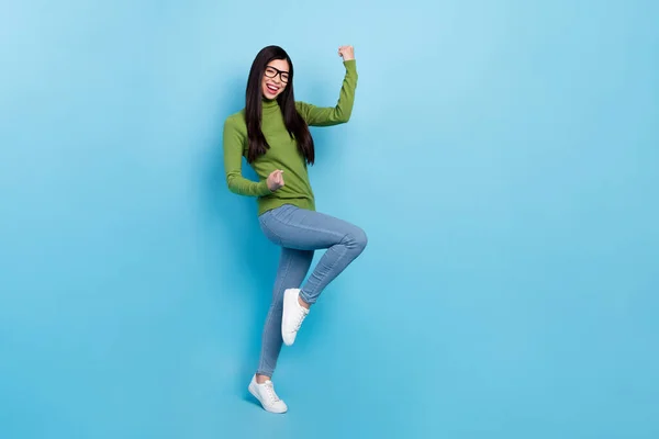 Full size photo of hooray millennial brunette lady yell wear eyewear jumper jeans sneakers isolated on blue color background — ストック写真