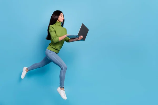 Full length body size view of beautiful trendy slim girl jumping running using laptop copy space isolated on shine blue color background — Foto de Stock