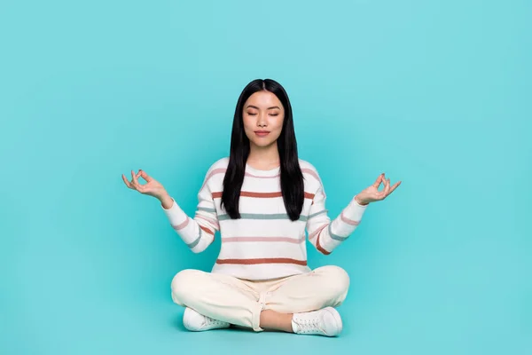 Photo of adorable calm peaceful young woman practice mindfulness open her chakras isolated on turquoise color background