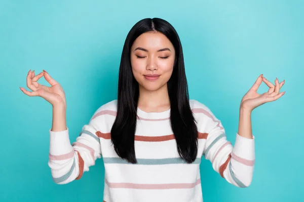 Photo of cute stunning chinese lady doing yoga with closed eyes have break during weekend isolated on teal color background — Stock Photo, Image