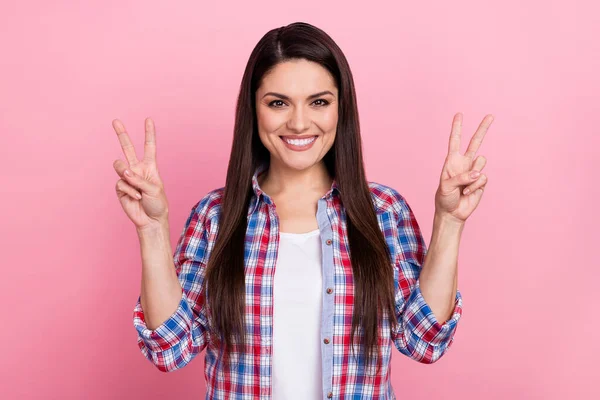 Photo of dreamy shiny woman wear plaid shirt showing two v-signs isolated pink color background — Fotografia de Stock