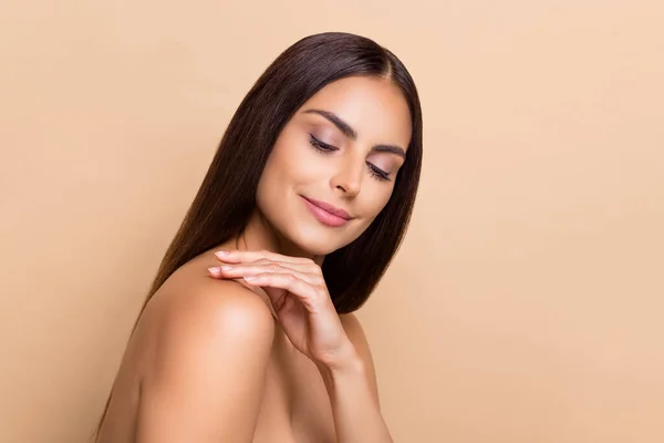 Profile side view portrait of attractive cheery dreamy girl touching flawless soft skin isolated over beige pastel color background — Φωτογραφία Αρχείου