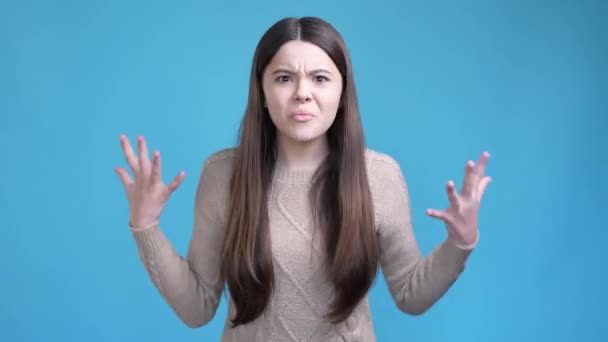 Angry teen kid shout misunderstanding isolated blue color background — Video