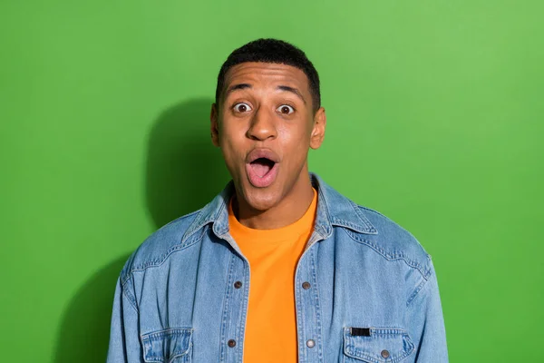 Portrait of young crazy overjoyed man see huge discounts on black friday bargain isolated on green color background — Stockfoto