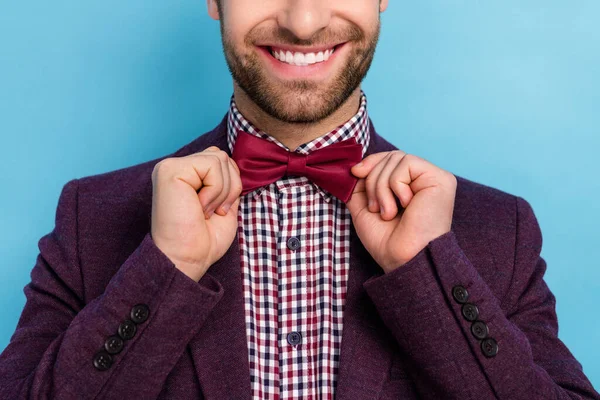 Cropped photo of beaming good mood man adjust bowtie go on date holiday party isolated on blue color background — Stok fotoğraf