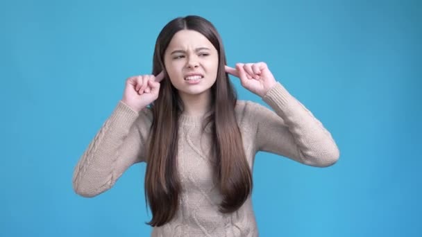 Frustrated teen lady not like loud sound quiet isolated blue color background — стоковое видео