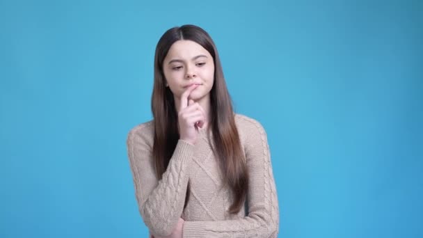 Pensive teen lady think thought shrug hands isolated blue color background — Stockvideo