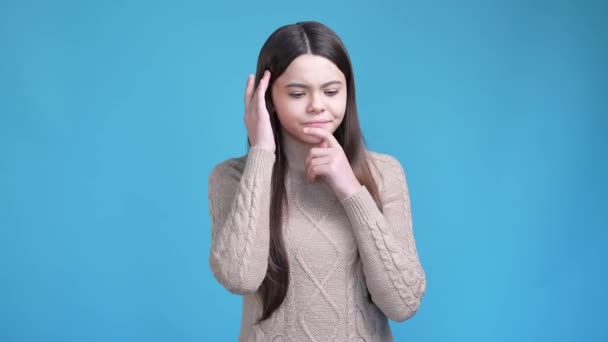 Pensive teen lady try find smart conclusion isolated blue color background — Video