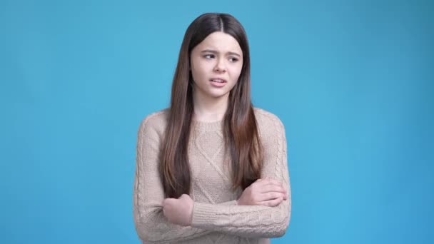 Teen hispanic lady crossing hands feel offense isolated blue color background — Video