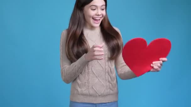 Cute lovely teen get red heart fist up win isolated blue color background — Vídeo de Stock