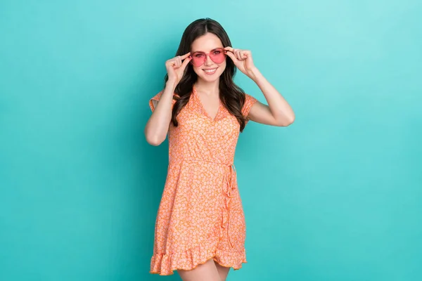 Foto av söt söt dam klädd orange kläder hjärta glasögon ler isolerad teal färg bakgrund — Stockfoto