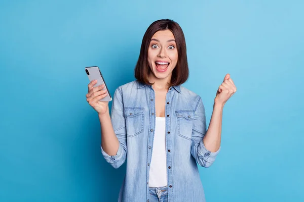 Portrait of delighted lady celebrate success follow subscribe like isolated on blue color background — ストック写真