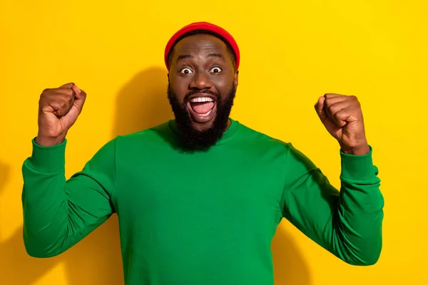 Portrait of attractive crazy lucky cheerful guy rejoicing having fun isolated over bright yellow color background — Stockfoto