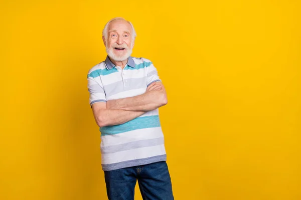 Portrait of attractive cheerful grey haired amazed man folded arms copy space ad news isolated over bright yellow color background — 스톡 사진