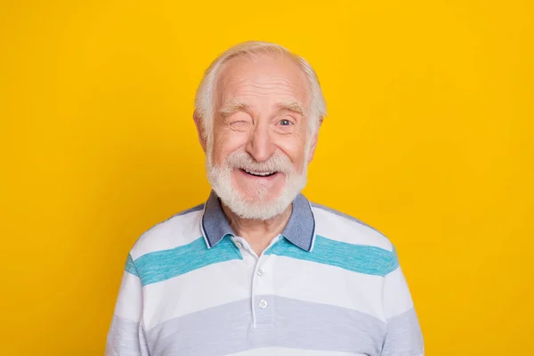 Portrait of attractive cheerful funny grey haired man smiling friendly winking isolated over vivid yellow color background — Stok fotoğraf