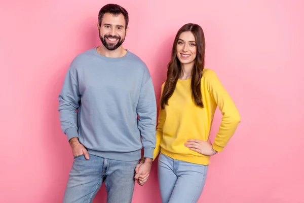 Portrait of two cheerful lovely people hold arms toothy smile isolated on pink color background — ストック写真
