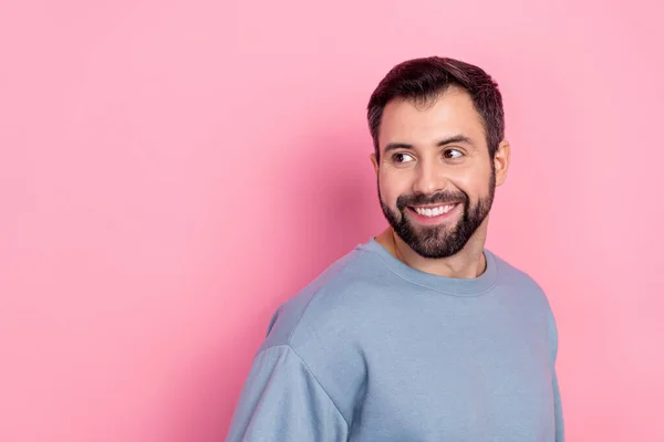 Retrato de atraente alegre homem de cabelos castanhos olhando para o lado cópia espaço isolado sobre cor pastel rosa fundo — Fotografia de Stock