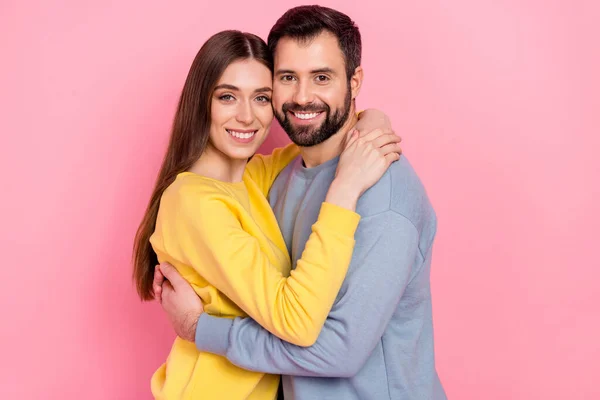 Portrait of two lovely peaceful people embrace toothy smile look camera isolated on pink color background — Stockfoto