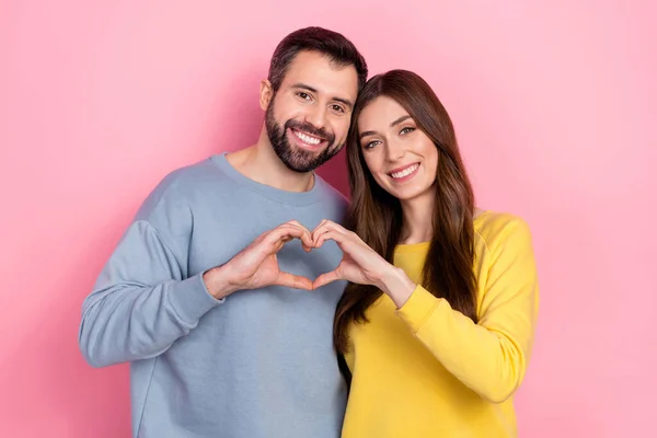Photo of two idyllic peaceful people hands fingers demonstrate heart symbol isolated on pink color background — Stockfoto