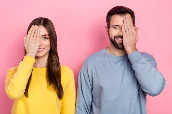 Photo of two cheerful people arm palm cover eye toothy smile look camera isolated on pink color background — Stock Fotó