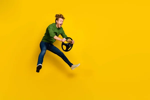 Full length photo of pretty impressed guy dressed sweater driving vehicle empty space isolated yellow color background — Stock Photo, Image