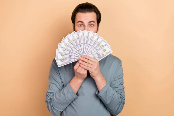 Photo of young man wealthy cover face money profit benefit salary isolated over beige color background — Stock Photo, Image