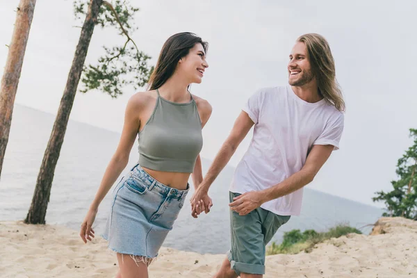 Photo of adorable pretty two people together holding arms enjoying good weather walking outside ocean water — Stock Photo, Image