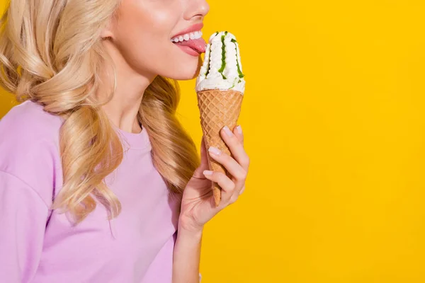 Profil photo recadrée de jeune fille langue lécher la crème glacée isolé sur fond jaune vif — Photo