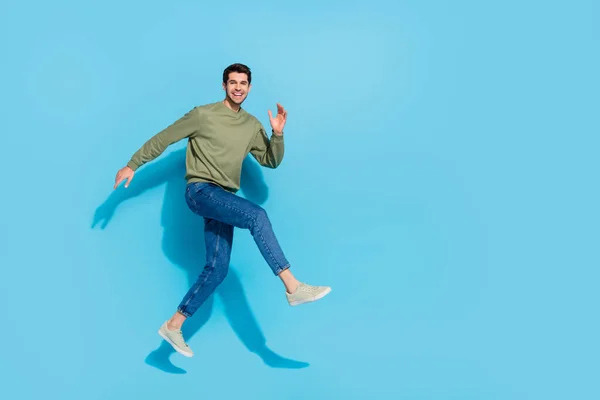 Full body photo of excited crazy person hurry rush fast empty space isolated on blue color background — Stock Photo, Image