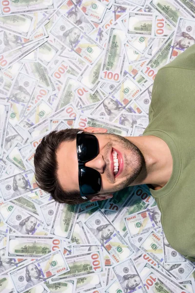 Vertical portrait of cheerful person laying usd banknotes money ocean isolated on money background — Stock Photo, Image